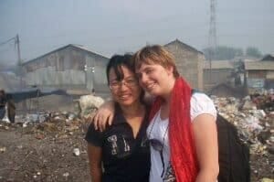 Two women with Dissociative Identity Disorder posing for a photo in a slum.