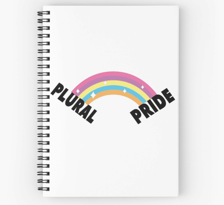 A spiral notebook featuring a rainbow with the words "plural pride" representing The Plural Association and Dissociative Identity Disorder/OSDD.
